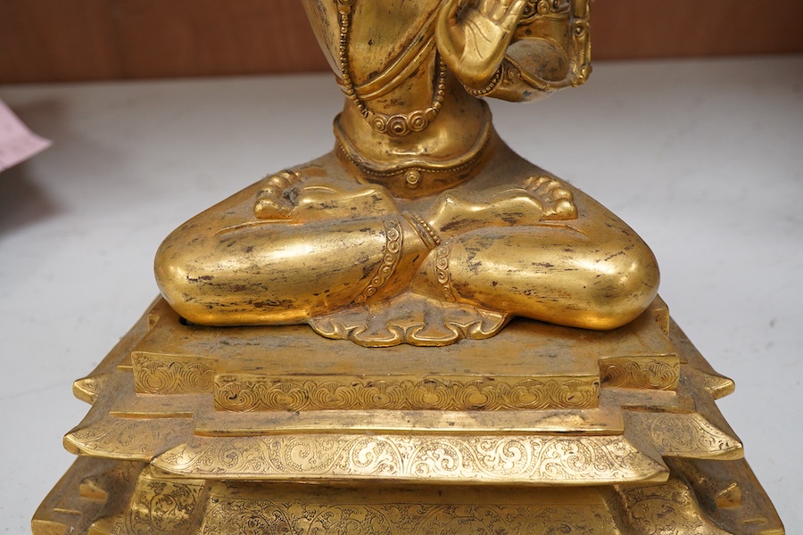 A gilt bronze figure of Manjushri, 31cm